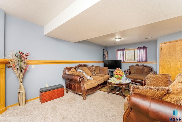 living area with baseboards and carpet floors