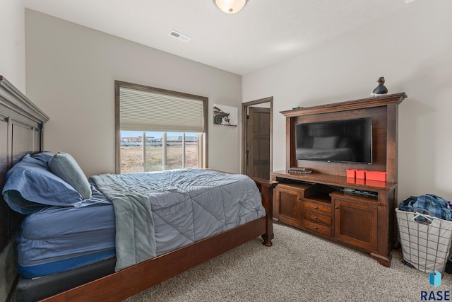bedroom with visible vents and light carpet