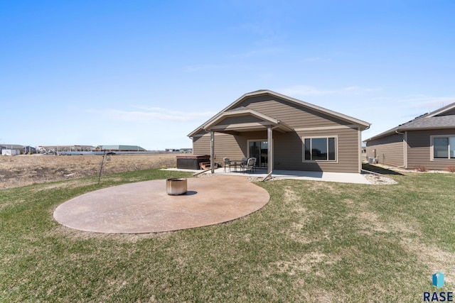 rear view of house with a patio area and a lawn