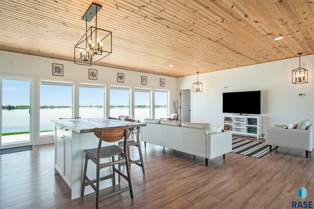 interior space with dark wood-style flooring, wooden ceiling, an inviting chandelier, and plenty of natural light