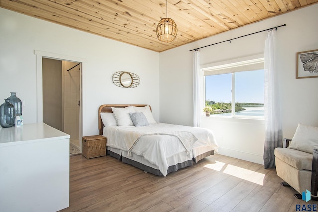 bedroom with baseboards, wooden ceiling, and wood finished floors