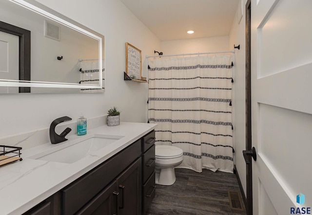 23744 461a Ave # 2, Wentworth, SD 57075 - full bath with vanity, visible vents, toilet, and wood finished floors