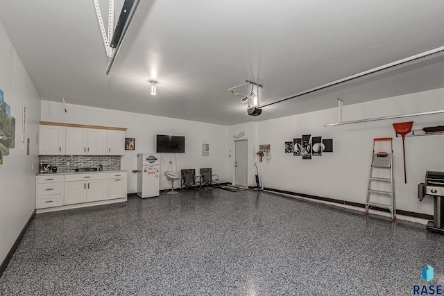 23744 461a Ave # 2, Wentworth, SD 57075 - garage featuring a garage door opener and baseboards