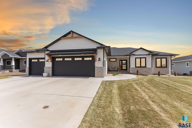 view of front facade featuring roof with shingles, driveway, board and batten siding, an attached garage, and a front lawn