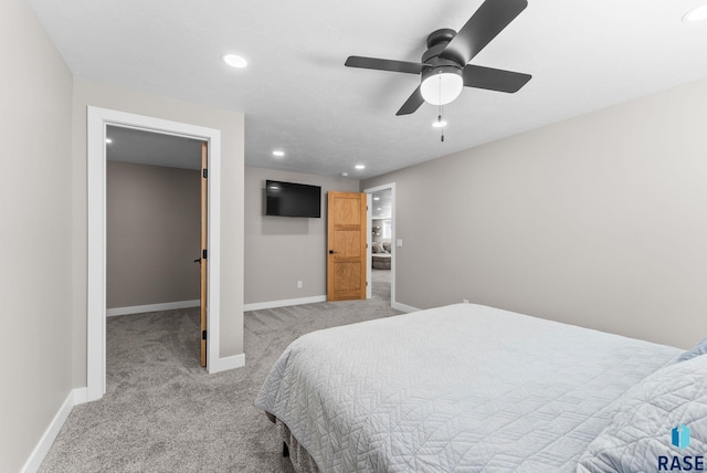 carpeted bedroom with recessed lighting, a walk in closet, baseboards, and a ceiling fan