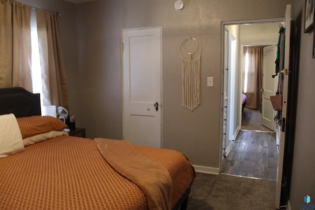 carpeted bedroom featuring baseboards