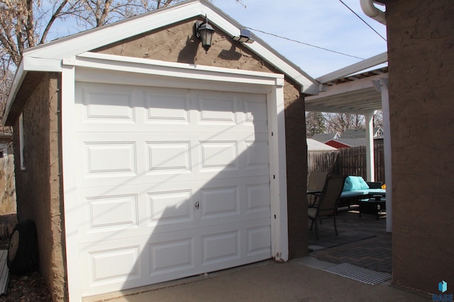 detached garage featuring fence