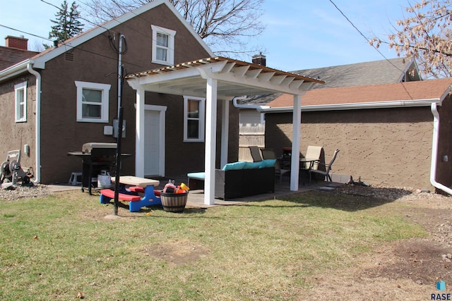 rear view of property featuring a chimney, a pergola, a yard, a patio, and an outdoor living space