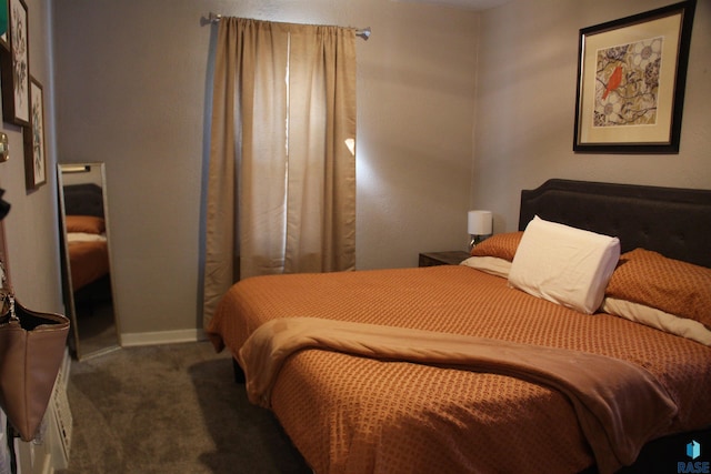 bedroom featuring baseboards and carpet