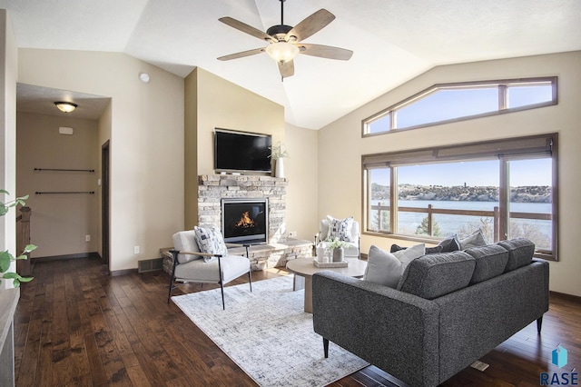 living room with dark wood-style flooring, a fireplace, a ceiling fan, and lofted ceiling