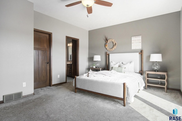 bedroom featuring visible vents, baseboards, ceiling fan, carpet, and ensuite bath