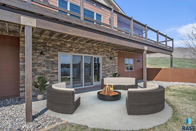 view of patio / terrace featuring an outdoor living space with a fire pit and a wooden deck