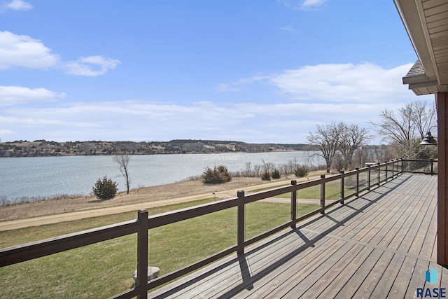 wooden terrace featuring a water view and a yard