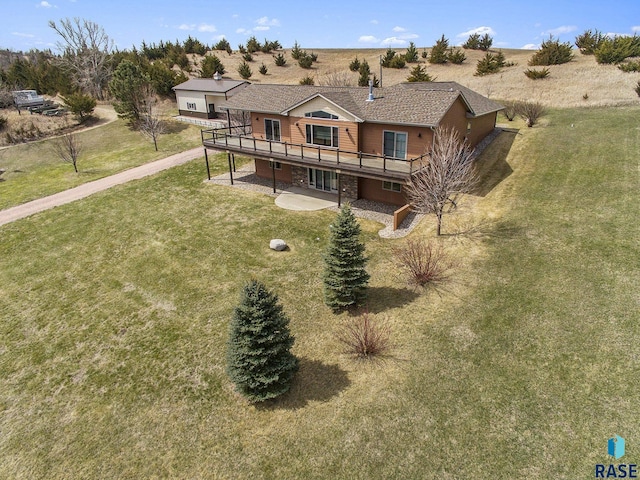 view of front facade featuring a patio area, a front yard, and a deck