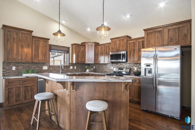 kitchen featuring dark wood-type flooring, decorative backsplash, and appliances with stainless steel finishes