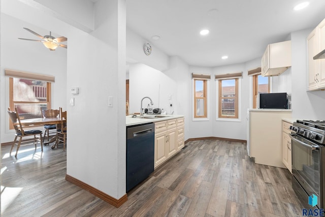 3325 E Manor Cir, Sioux Falls, SD 57103 - kitchen featuring stainless steel dishwasher, wood finished floors, a sink, and range with gas cooktop