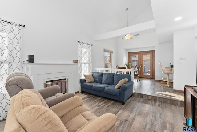 3325 E Manor Cir, Sioux Falls, SD 57103 - living room featuring baseboards, a fireplace, a ceiling fan, high vaulted ceiling, and wood finished floors