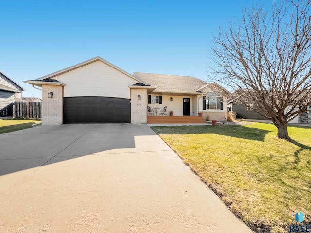 604 Eagle Ave, Harrisburg, SD 57032 - ranch-style house with covered porch, a front yard, brick siding, an attached garage, and concrete driveway