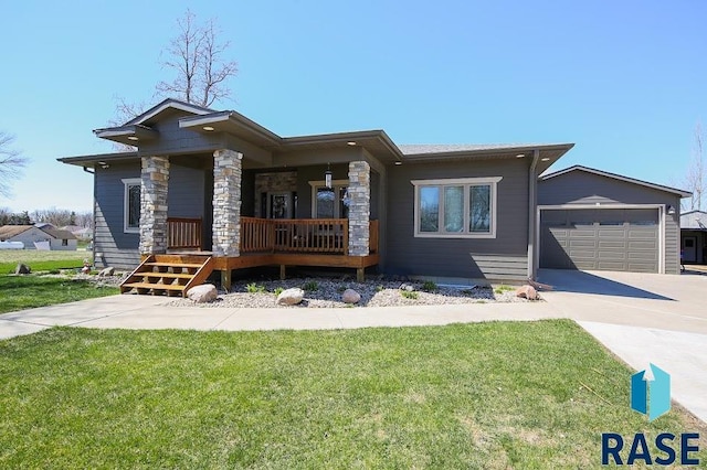 105 N Nora St, Viborg, SD 57070 - view of front of home with a front yard, covered porch, a garage, and concrete driveway