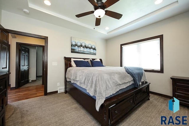105 N Nora St, Viborg, SD 57070 - carpeted bedroom featuring a raised ceiling, baseboards, and recessed lighting