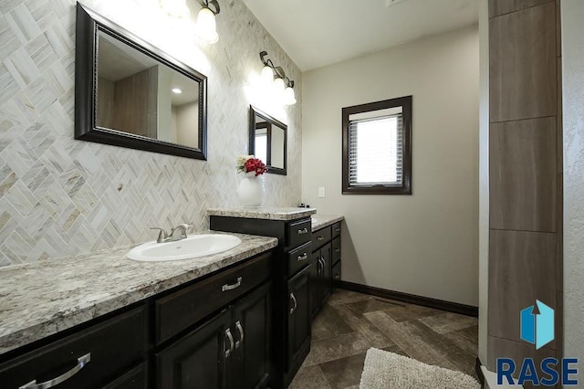 105 N Nora St, Viborg, SD 57070 - bathroom featuring a sink, backsplash, baseboards, and two vanities