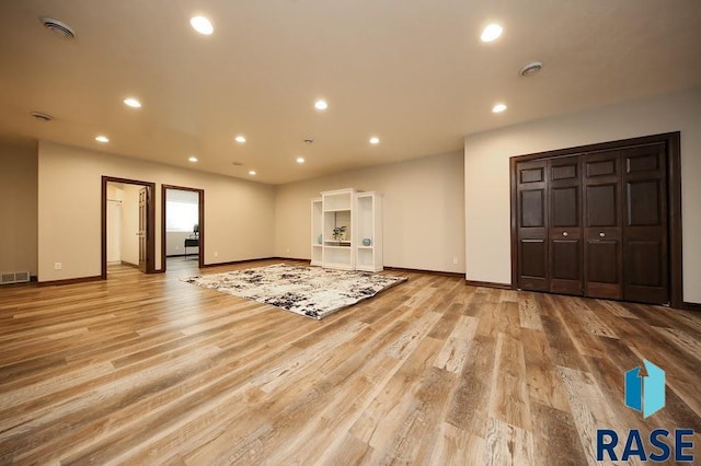 105 N Nora St, Viborg, SD 57070 - unfurnished living room with visible vents, baseboards, recessed lighting, and wood finished floors
