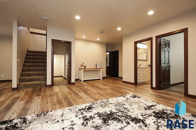105 N Nora St, Viborg, SD 57070 - unfurnished living room featuring wood finished floors, recessed lighting, baseboards, and stairs