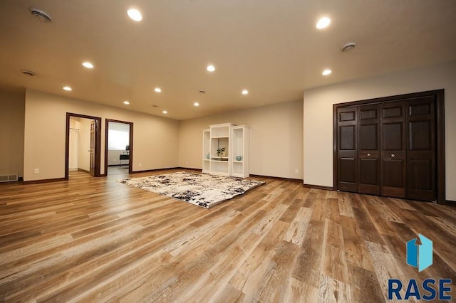 105 N Nora St, Viborg, SD 57070 - unfurnished living room with visible vents, baseboards, recessed lighting, and wood finished floors