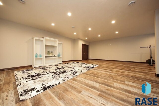 105 N Nora St, Viborg, SD 57070 - unfurnished living room with recessed lighting, baseboards, and wood finished floors