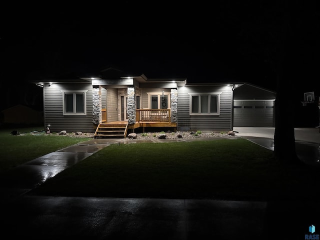 105 N Nora St, Viborg, SD 57070 - view of front of home with a porch, a garage, and a lawn