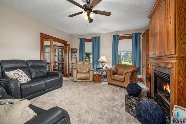 28128 462nd Ave, Davis, SD 57021 - carpeted living room with a textured ceiling, ceiling fan, and a high end fireplace