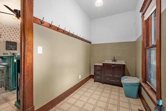 28128 462nd Ave, Davis, SD 57021 - bathroom with tile patterned floors, vanity, baseboards, and ceiling fan