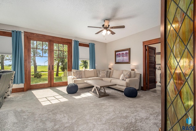 28128 462nd Ave, Davis, SD 57021 - carpeted living area featuring french doors, a ceiling fan, and a textured ceiling