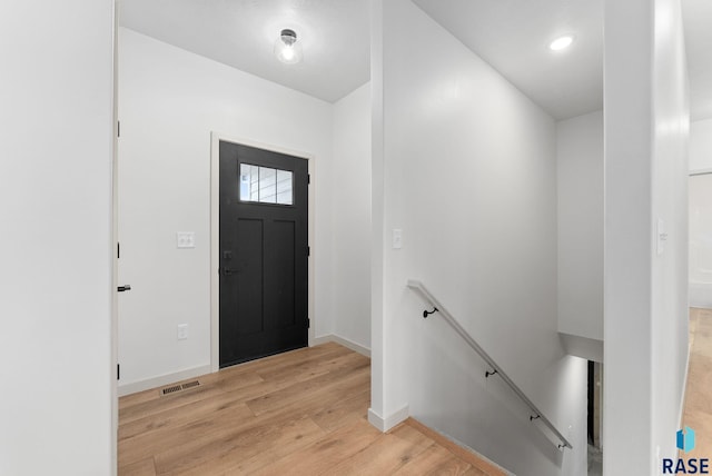 entrance foyer featuring light wood-type flooring, baseboards, and visible vents