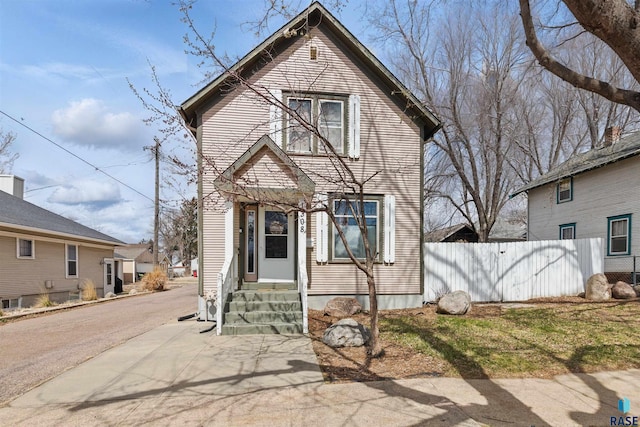 view of front of home with fence and entry steps