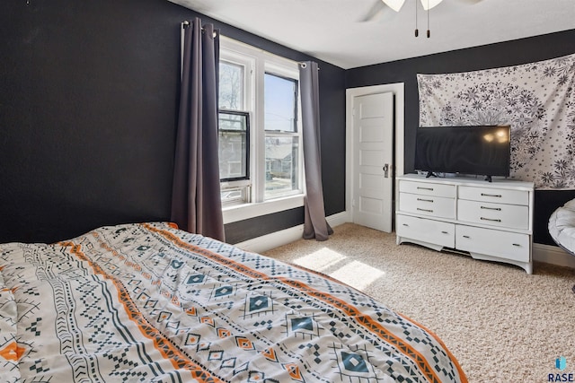 bedroom featuring baseboards, a ceiling fan, and light colored carpet