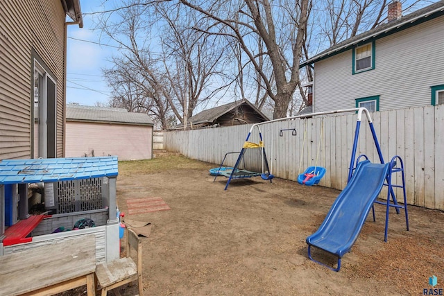 view of yard featuring a fenced backyard and a playground