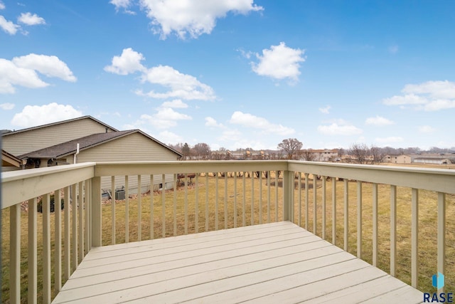 wooden terrace with a lawn