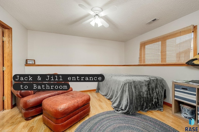 bedroom featuring wood finished floors, a textured ceiling, and a ceiling fan
