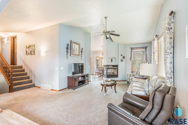6520 S Heatherridge Trl, Sioux Falls, SD 57108 - living area featuring vaulted ceiling, visible vents, carpet floors, stairs, and baseboards