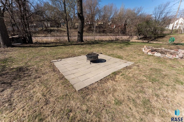 view of yard with an outdoor fire pit and a patio area