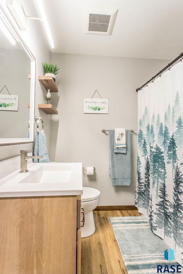 1000 N Six Mile Rd, Sioux Falls, SD 57110 - bathroom with vanity, baseboards, toilet, visible vents, and wood finished floors