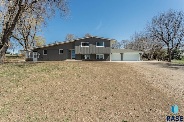 1000 N Six Mile Rd, Sioux Falls, SD 57110 - split level home with driveway, a garage, and a front lawn