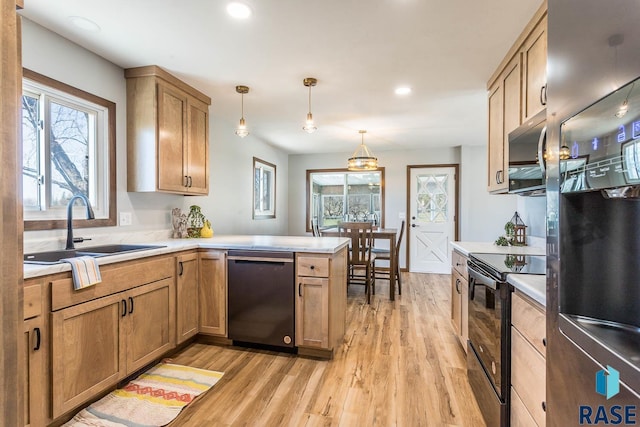 1000 N Six Mile Rd, Sioux Falls, SD 57110 - kitchen with a sink, light wood-style floors, appliances with stainless steel finishes, and a peninsula