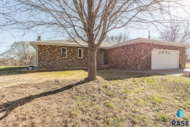 ranch-style home with a garage, a front yard, brick siding, and a chimney