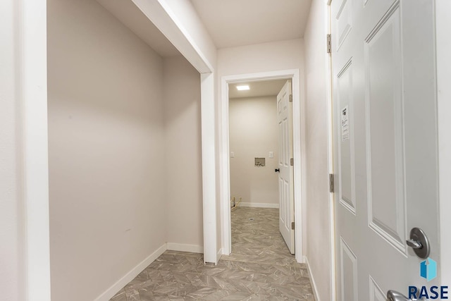 hallway featuring baseboards