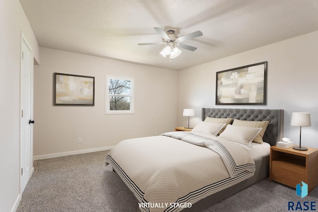 carpeted bedroom with ceiling fan, baseboards, and a textured ceiling