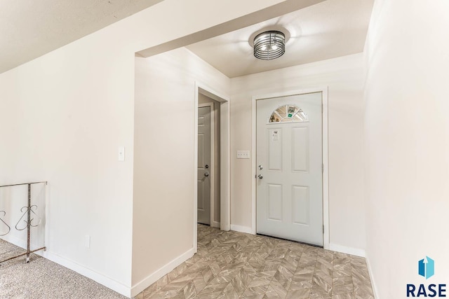 entryway featuring baseboards