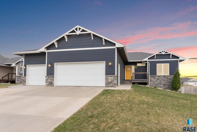 5320 S Solono Ave, Sioux Falls, SD 57108 - craftsman-style house with an attached garage, stone siding, and a lawn