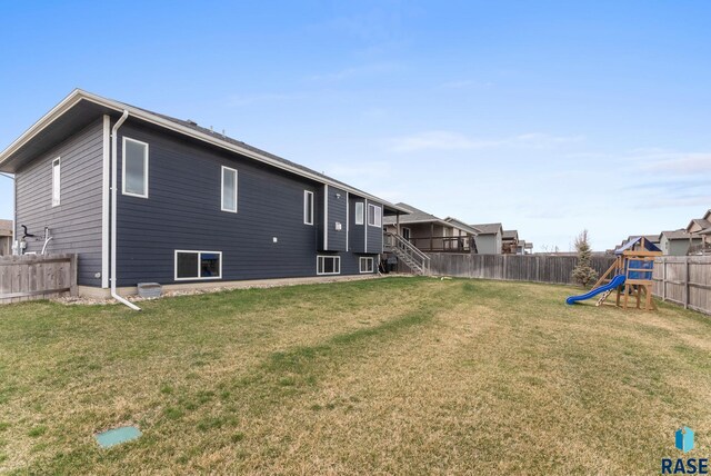 5320 S Solono Ave, Sioux Falls, SD 57108 - back of house featuring a yard, a fenced backyard, and a playground